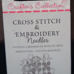 May include: A package of "Crafter's Collection" cross stitch and embroidery needles. The package has the text "CROSS STITCH & EMBROIDERY Needles" in large, bold letters. The package also has the text "AIGUILLES À BRODERIE ET POINT DE CROIX KREUZSTICH- UND STICKNADELN".