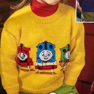 May include: A yellow knitted sweater with a Thomas the Tank Engine design. The sweater features three engines: Thomas, Percy, and Toby. The engines are embroidered in red, blue, and green.