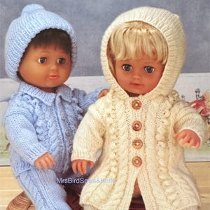 May include: Two dolls dressed in knitted outfits. One doll wears a light blue hat, jacket, and pants. The other doll is in a cream-colored hooded jacket and pants. The outfits have cable knit detailing. The text "MrsBirdSews&Knits" is visible.