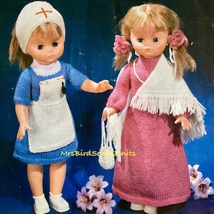 May include: Two knitted doll outfits, one in blue and white with a nurse's hat and the other in pink with a white shawl. The dolls are not included.
