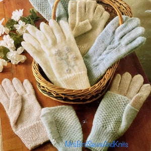 May include: A wicker basket filled with four pairs of knitted gloves. The gloves are in various shades of blue and white. Some of the gloves have a cable knit pattern, while others have a simple stitch.