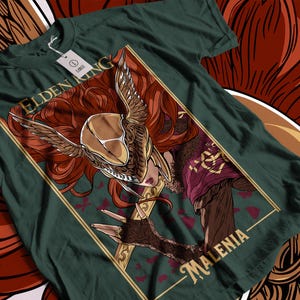 May include: Dark green t-shirt featuring a detailed illustration of a character from Elden Ring. The artwork includes a winged helmet, red hair, and the name "MALENIA". The shirt has a tag that says "LARGE".