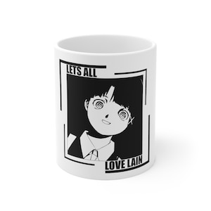 May include: White ceramic mug featuring a black and white anime-style illustration of a character with spiral eyes. The text "LETS ALL LOVE LAIN" is printed in black on the mug, which is a standard size for coffee or tea.