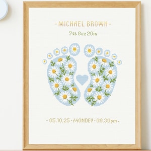 Peut inclure: Un cadre de point de croix de naissance avec le nom MICHAEL BROWN, les détails 7lb 8oz 20in, et la date 05.10.25-MONDEV-08.30pm. Le motif montre deux empreintes de pieds de bébé remplies de marguerites blanches et un cœur bleu central.