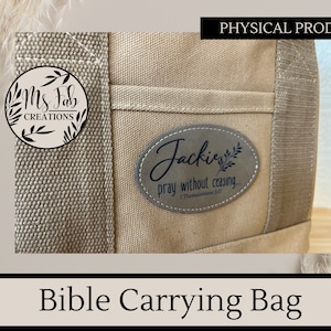 May include: Beige canvas tote bag with a brown leather patch that says "Jacki pray without ceasing... 1 Thessalonians 5:17". The bag has a black and white logo that says "Ms Fab Creations" on the front.