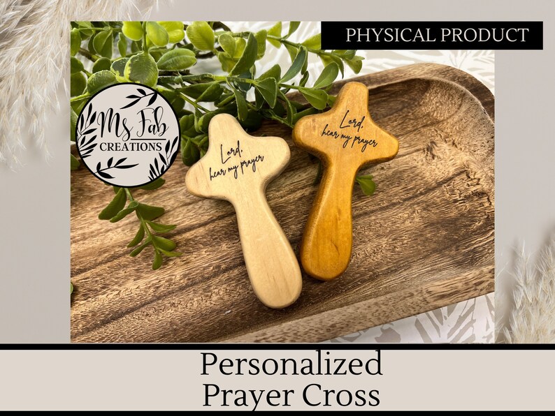 May include: Two wooden prayer crosses with the text "Lord, hear my prayer" engraved on them. The crosses are on a wooden tray.
