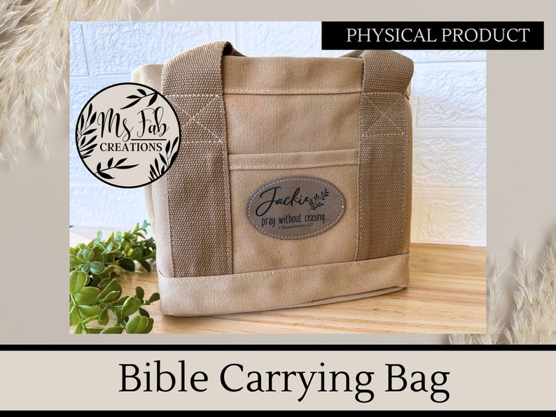 May include: A beige canvas Bible carrying bag with a brown leather patch that says "Jackie's Pray without ceasing 1 Thessalonians 5:17".