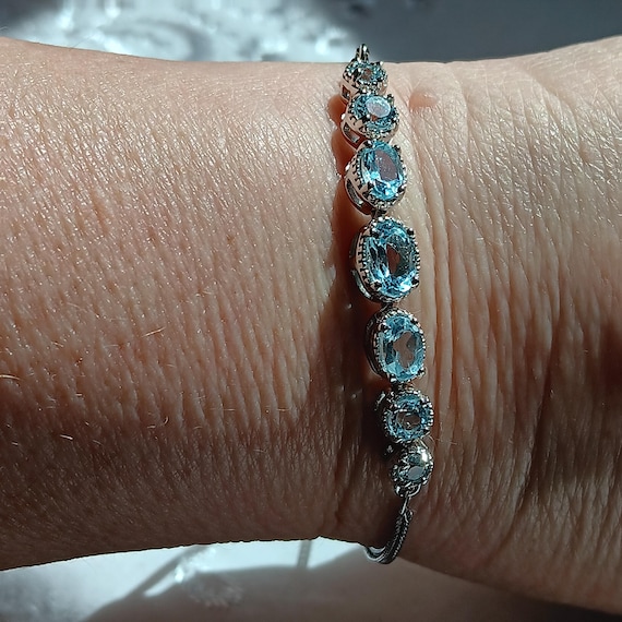 Genuine Blue Topaz Adjustable Bracelet In Silvertone
