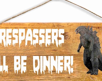 Letrero de madera de 6 x 15: Los intrusos serán la cena, dice Godzilla.