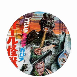 May include: A vintage movie poster for the Japanese film "Godzilla vs. Megalon" featuring Godzilla, Megalon, and other monsters in a battle scene. The poster is in Japanese and features a red, orange, and yellow sunset background.