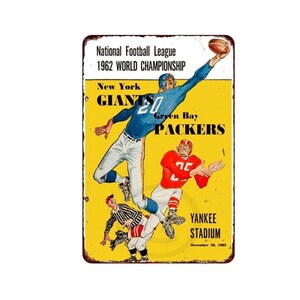 May include: Vintage metal sign featuring a football game illustration. The sign displays the text "National Football League 1962 WORLD CHAMPIONSHIP" with "New York GIANTS" and "Green Bay PACKERS" in bold letters. The sign also includes "YANKEE STADIUM" and the date "December 30, 1962".