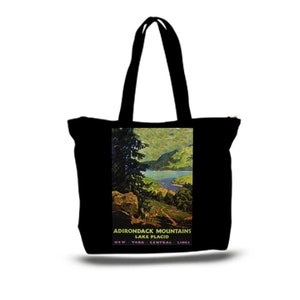 May include: Black canvas tote bag with a vintage travel poster design featuring a scenic view of a lake and mountains. The text on the poster reads "Adirondack Mountains Lake Placid New York Central Lines".