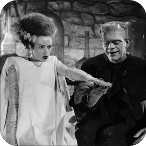 May include: A black and white photo of a woman with a white dress and a man with a dark suit. The woman is reaching out to the man with her hand. The man is looking at the woman's hand.