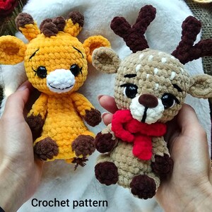 May include: A crocheted giraffe and reindeer plush toy set. The giraffe is yellow with brown spots and the reindeer is brown with white spots. Both toys have big eyes and are holding a red scarf.