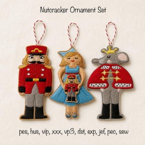 May include: A Nutcracker Ornament Set featuring three embroidered felt figures with red and white hanging strings. The designs include a soldier in a red uniform, a figure in a blue dress holding a nutcracker, and a mouse king in a red cape.