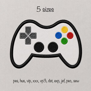 May include: An embroidered patch of a white video game controller with a thick black outline. It features a gray directional pad, two black circular buttons, and four colored action buttons in yellow, blue, red, and green. Text reads 5 sizes and file formats pes, hus, vip, xxx, vp3, dst, exp, jef, pec, sew.