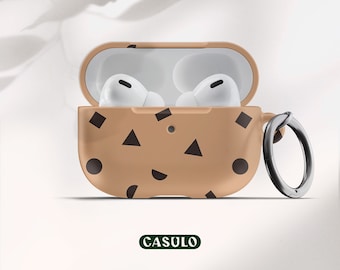 May include: A brown and black patterned protective case for wireless earbuds with a carabiner clip. The case has a cookie design with chocolate chips and a CASULO logo.