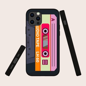May include: A black phone case with a retro cassette tape design. The cassette tape is orange, pink, and white with the text "AUDIO TAPE LH 60" and "A".