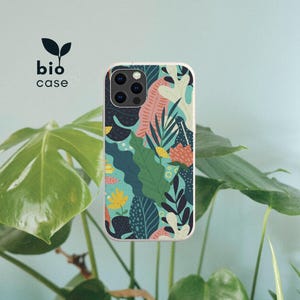 May include: A smartphone case featuring a vibrant botanical pattern with various leaf shapes in shades of dark blue, green, yellow, and coral on a light blue background. The text bio case with a small leaf icon is printed in the upper left corner.