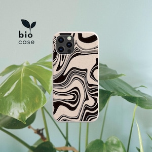 May include: A phone case with a black and beige marbled swirl pattern. The case features a triple camera cutout on the top left corner. The text bio case with a small leaf icon is positioned above the phone case on the left side.