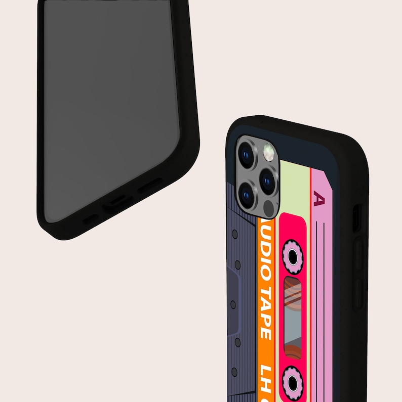 May include: Black phone case with a retro cassette tape design. The case features a pink and orange cassette tape with the text "AUDIO TAPE LH" and "A" on the case.