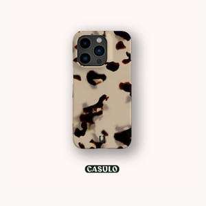 May include: A beige and brown iPhone case with a tortoiseshell pattern. The case has a small, black "U" logo in the centre.