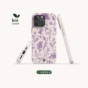 May include: A phone case with a light beige speckled base and a purple botanical floral pattern. The case features a camera cutout, side buttons, and a bottom charging port opening. The text bio case and CASULO are visible in the image.