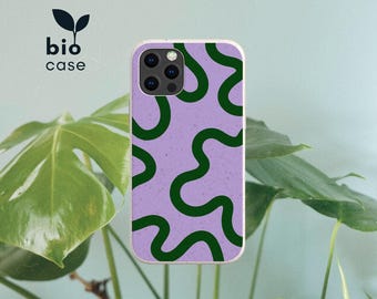 May include: A phone case featuring a light purple background with a dark green wavy line pattern. The case has a cutout for a triple camera system on the top left. The text bio case with a small leaf icon is visible in the upper left corner.