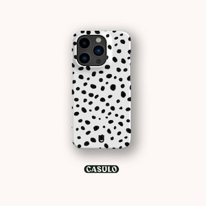 May include: White phone case with a black dalmatian spot pattern. The case has a black camera bump with three lenses and a flash.