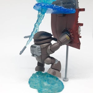 May include: A brown and gray robot figure holding a red and gray flag with a blue water effect. The robot is standing on a blue water effect base.
