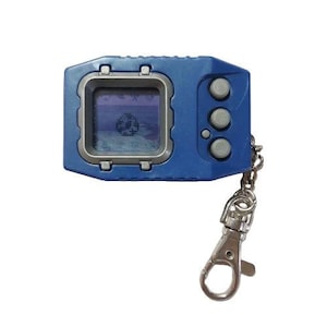 May include: A blue handheld digital pet device with a small screen displaying pixelated graphics. It has three gray buttons on the side and a silver keychain clip attached. The device is a retro toy.