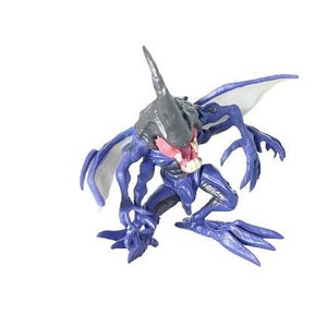 May include: A purple and gray alien action figure with wings and sharp claws. The figure has a menacing expression with a large mouth and sharp teeth.