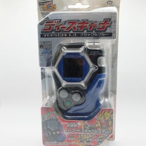 May include: A blue and silver Digimon toy with a digital screen that reads "DIGITAL CODE". The toy is in a plastic package with the text "Teescana Version 1.0 Black & Blue" and "New Mechanism Barcode Scan System!!!" on the front.