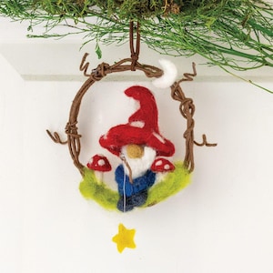 May include: A felt gnome ornament hanging from a twig wreath. The gnome is wearing a red hat with white spots and a blue outfit. The gnome is holding a fishing rod with a star at the end.