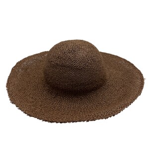 May include: A brown woven straw sun hat with a wide brim.