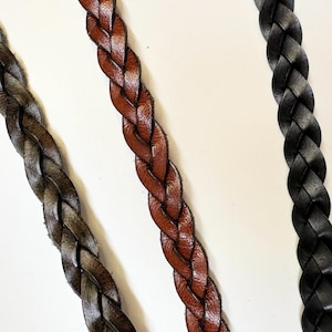 May include: Three braided leather straps in brown, dark brown, and black.