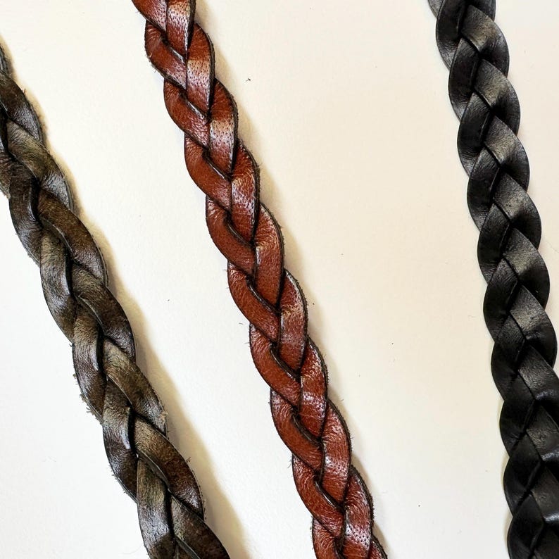 May include: Three braided leather straps in brown, dark brown, and black.