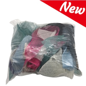 May include: A clear plastic bag filled with a variety of fabric scraps in different colors, including pink, blue, green, and white. The fabric scraps are made of a mesh material and appear to be new.