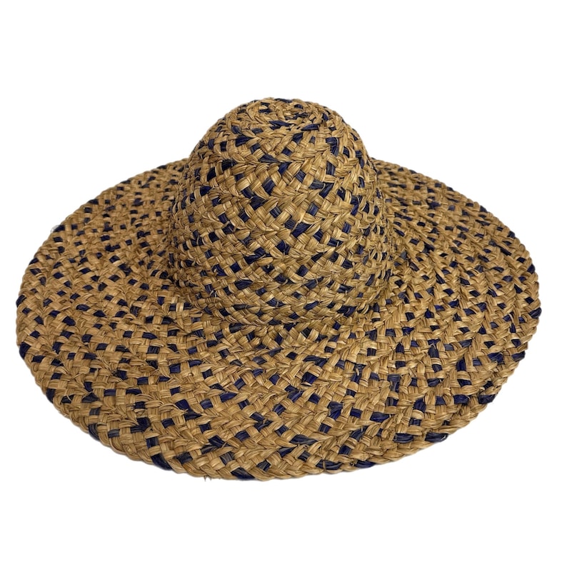 May include: A woven sun hat with a wide brim and a rounded crown. The hat features a natural tan colour with a dark blue woven pattern. The brim is wide, providing ample shade. This hat is perfect for sunny days and outdoor activities.