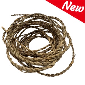 May include: Coiled natural fibre rope, tightly braided in a spiral pattern. The rope is a light brown colour, with a textured surface. A red banner in the upper right corner reads "New".