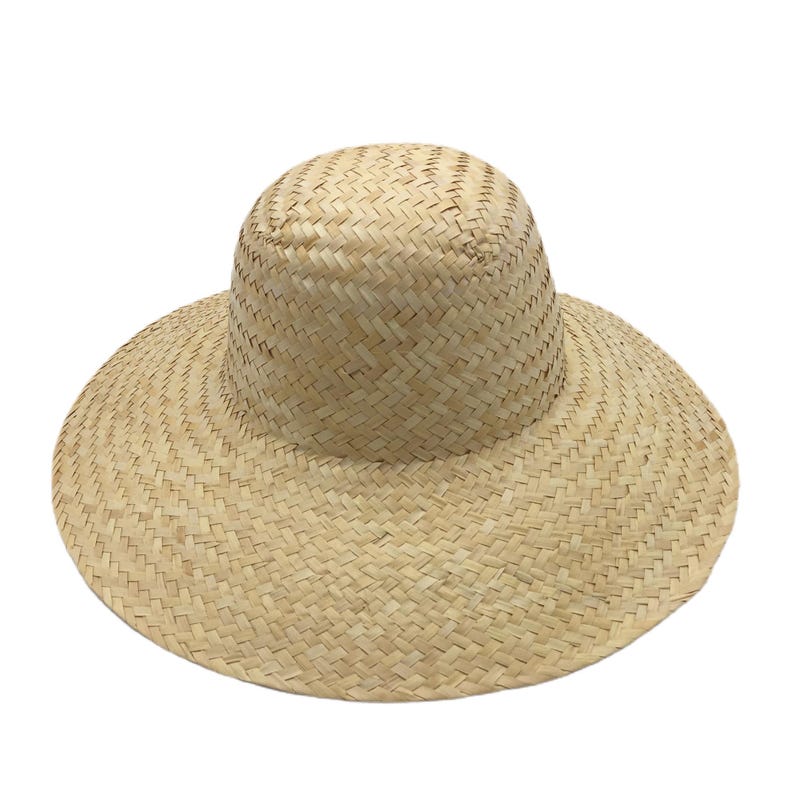 May include: A natural straw hat with a wide brim and a rounded crown. The hat is made of woven straw, with a tightly woven pattern on the crown and a wider weave on the brim. The hat is designed to provide shade from the sun.