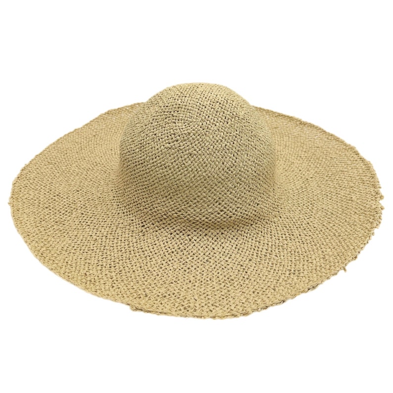 May include: A wide-brimmed straw hat with a woven texture. The hat is a light beige color and has a slightly rounded crown.