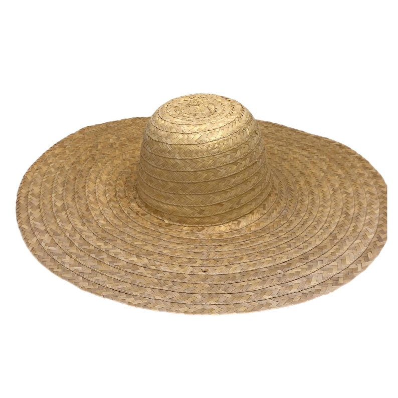 May include: A large sun hat made from woven straw. It has a rounded crown and a wide, circular brim. The natural straw colour gives it a classic, summery appearance. The hat is designed to provide ample shade from the sun.