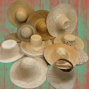 Collection of woven straw hats in various styles and sizes. The hats are in shades of beige and tan, with wide brims and varying crown heights.