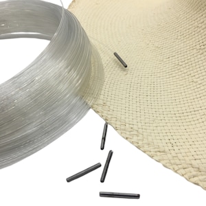 May include: A roll of clear plastic string, a woven straw hat, and several small metal pins.
