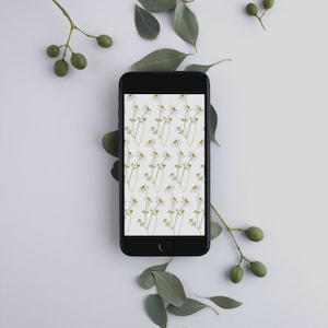May include: A black smartphone with a white background displaying a pattern of white daisies with green stems.