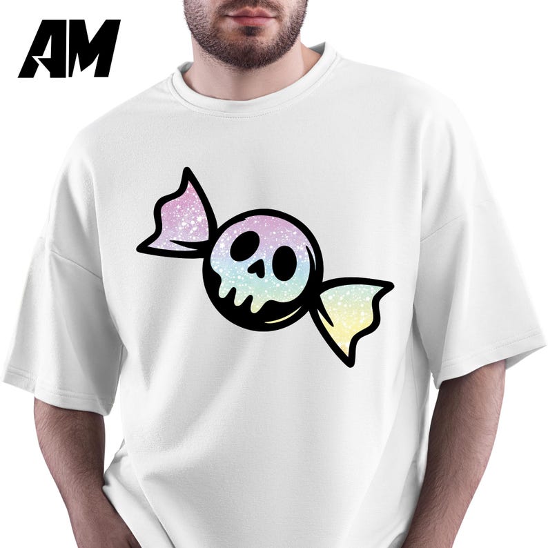 May include: White sweatshirt featuring a candy-shaped skull graphic. The skull is black with a pastel rainbow gradient, and the candy wrapper has pink and yellow accents. The letters "AM" are in the upper left corner.