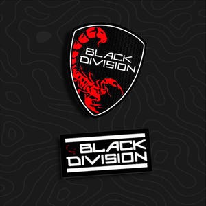 May include: Two embroidered patches featuring the text BLACK DIVISION. The top patch is shield-shaped with a red scorpion graphic. The bottom patch is rectangular with white text and a small red scorpion icon on the left side against a black background.