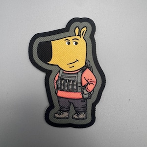 May include: A yellow cartoon character wearing a black tactical vest, a pink sweater, and black pants. The character has a black nose and a black outline.