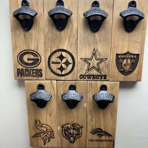 May include: Wooden bottle opener set featuring eight openers with the words "OPEN HERE" on each. The set includes team logos for the Packers, Steelers, Cowboys, Raiders, Vikings, Bears, and Broncos. The wood has a natural finish.